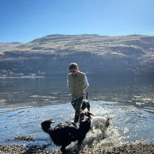 Ali Campbell with dogs in Loch Long