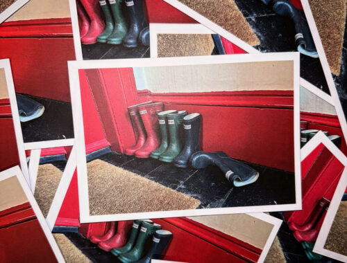 The Mansefield House postcard image of a line up of wellington boots