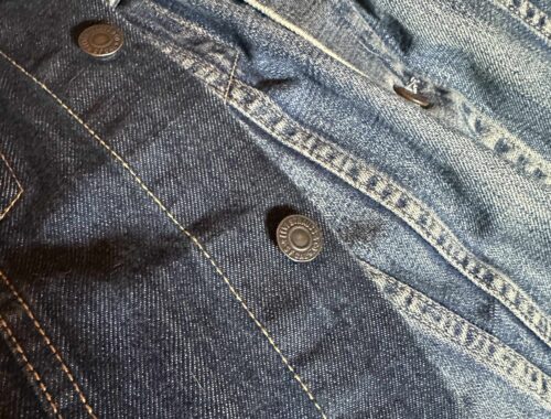 Contrasting denim jackets, one worn over the other. A vintage jacket overlaid with a blue indigo one